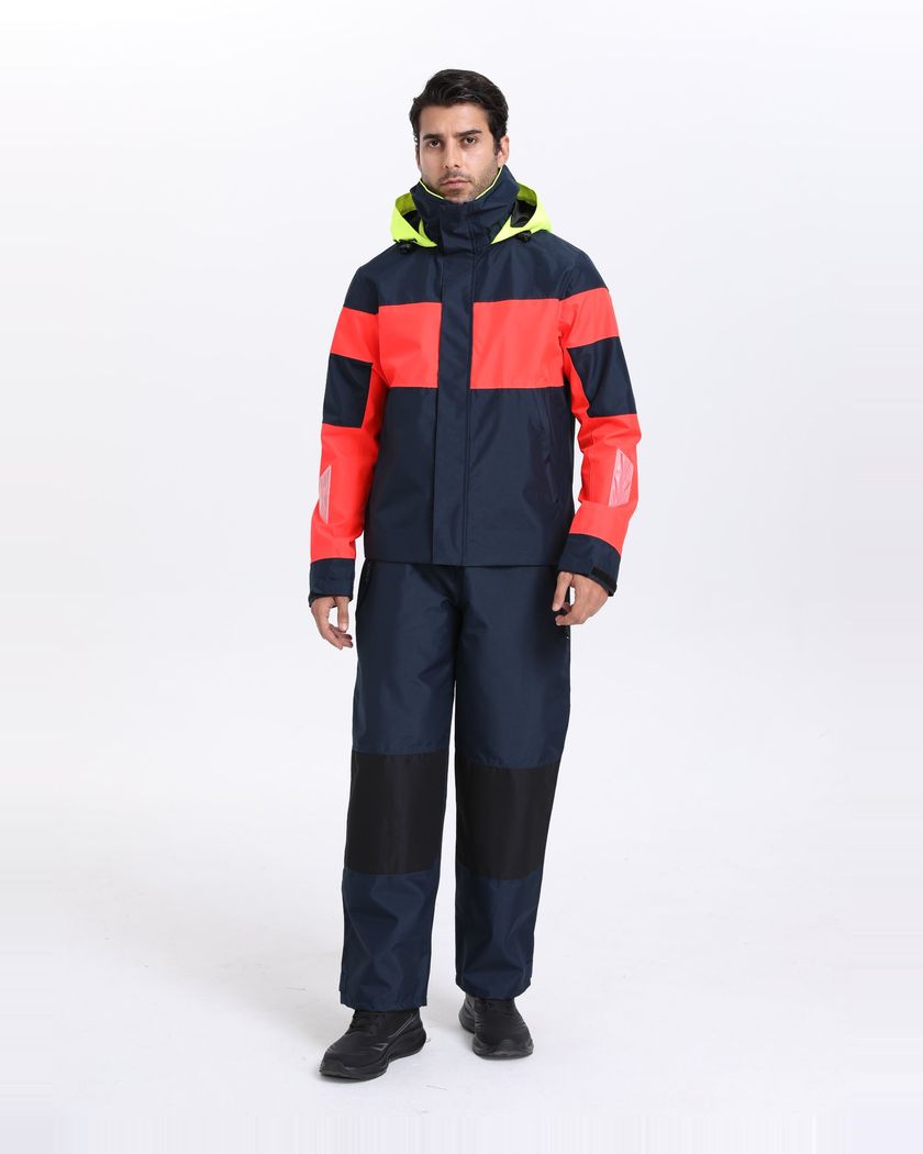 Navy and coral colour-block shell jacket and pants, front view with the hood stowed in the collar